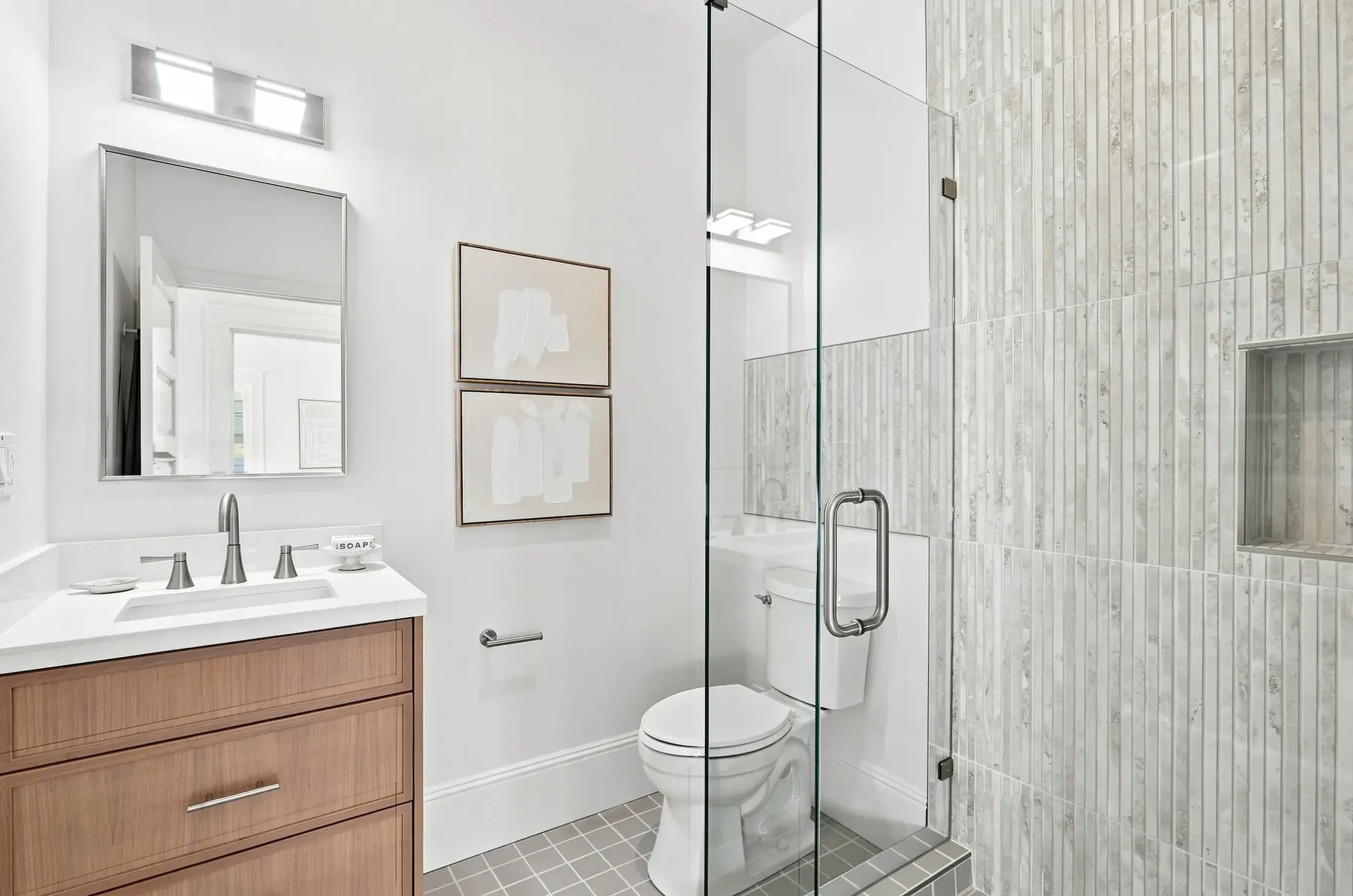 Second bath. Wood-look porcelain runs floor to ceiling in the wet area.