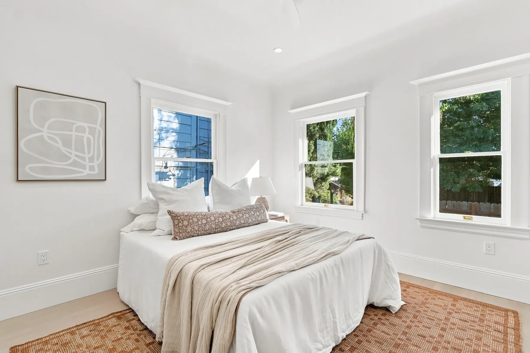 Second bedroom with a corner window pair and new sliding closet doors.
