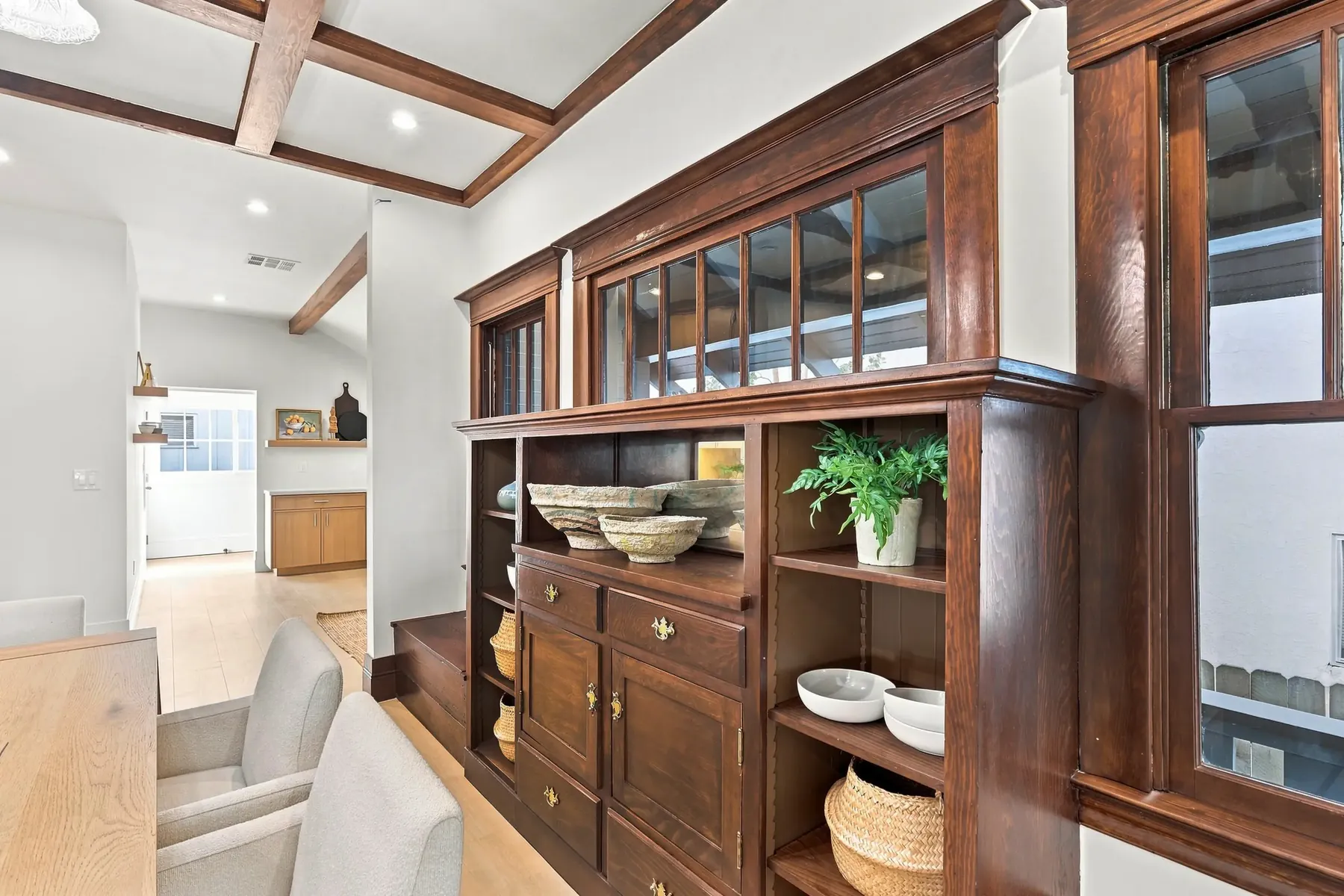 The original built-in dining hutch with leaded-glass uppers, stripped and refinished. Replacing this would have cost less than saving it.