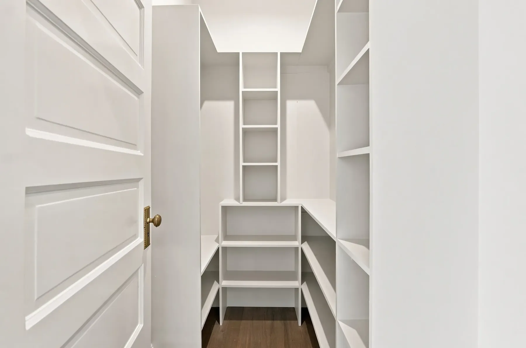 Built-in linen shelving in the hall, detailed to the same trim standard as the rest of the house.