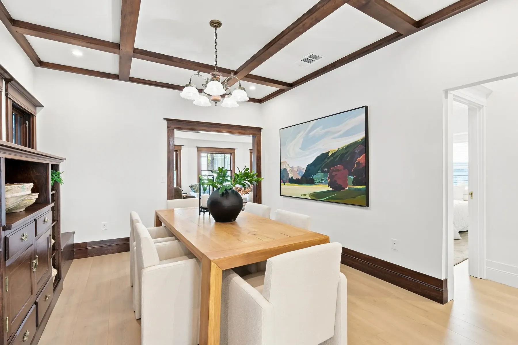 Box-beam ceiling in the dining room, refinished rather than covered. The white field between beams is new.