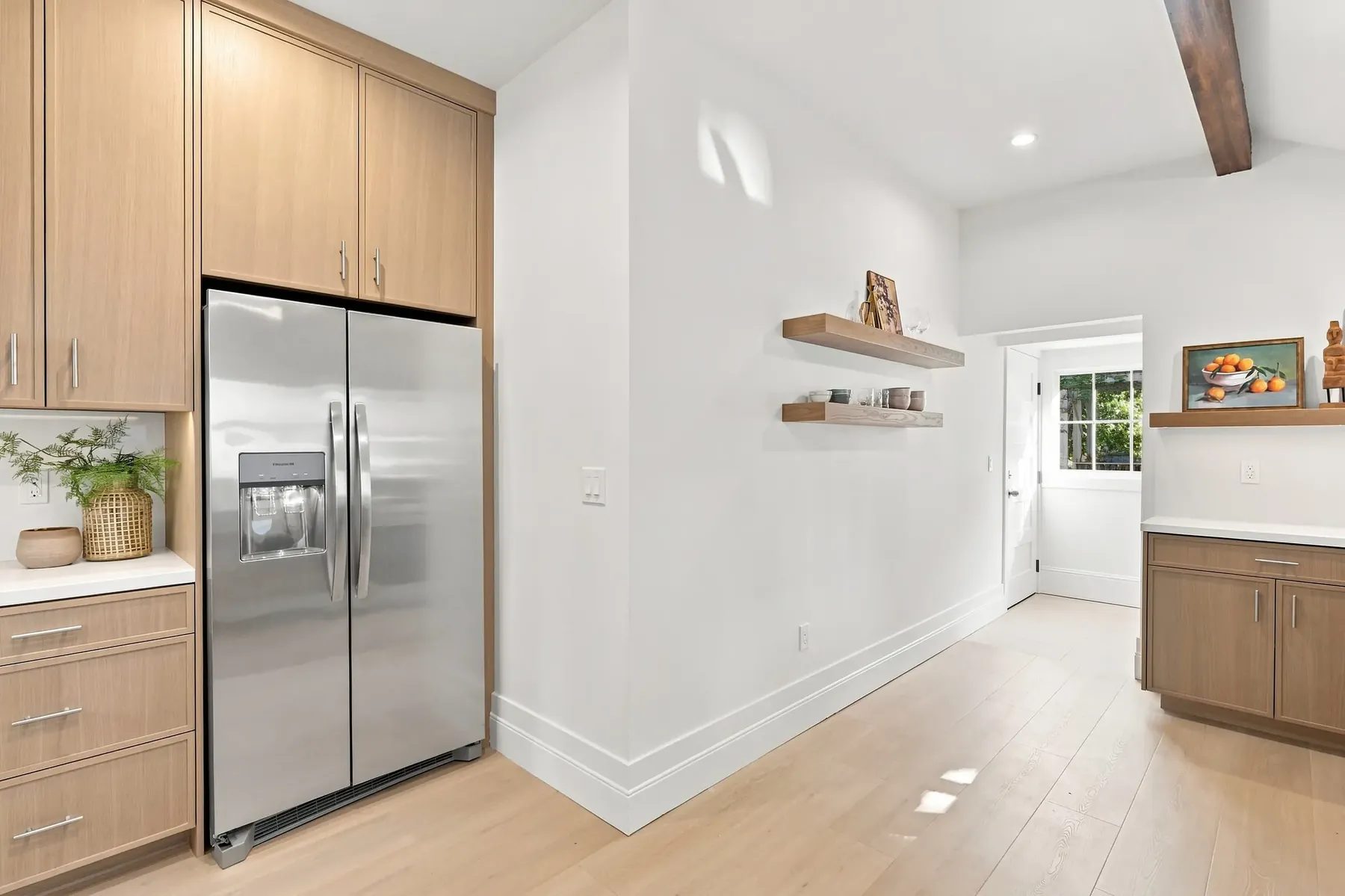 Tall cabinet and refrigerator wall with open shelving, and a new rear door to the deck.