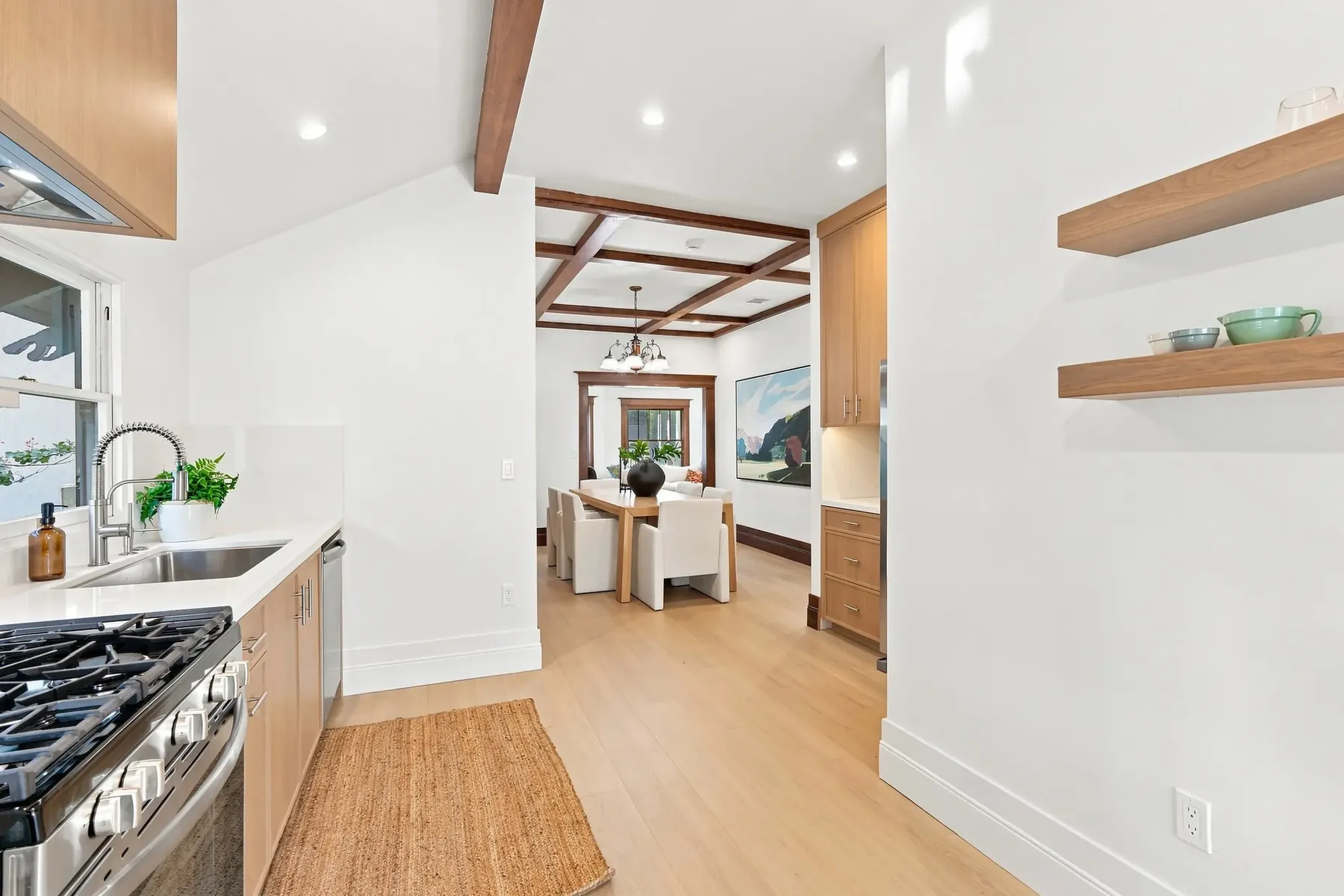 Where the two ceilings meet: vaulted kitchen on the left, original box-beam dining room straight ahead.