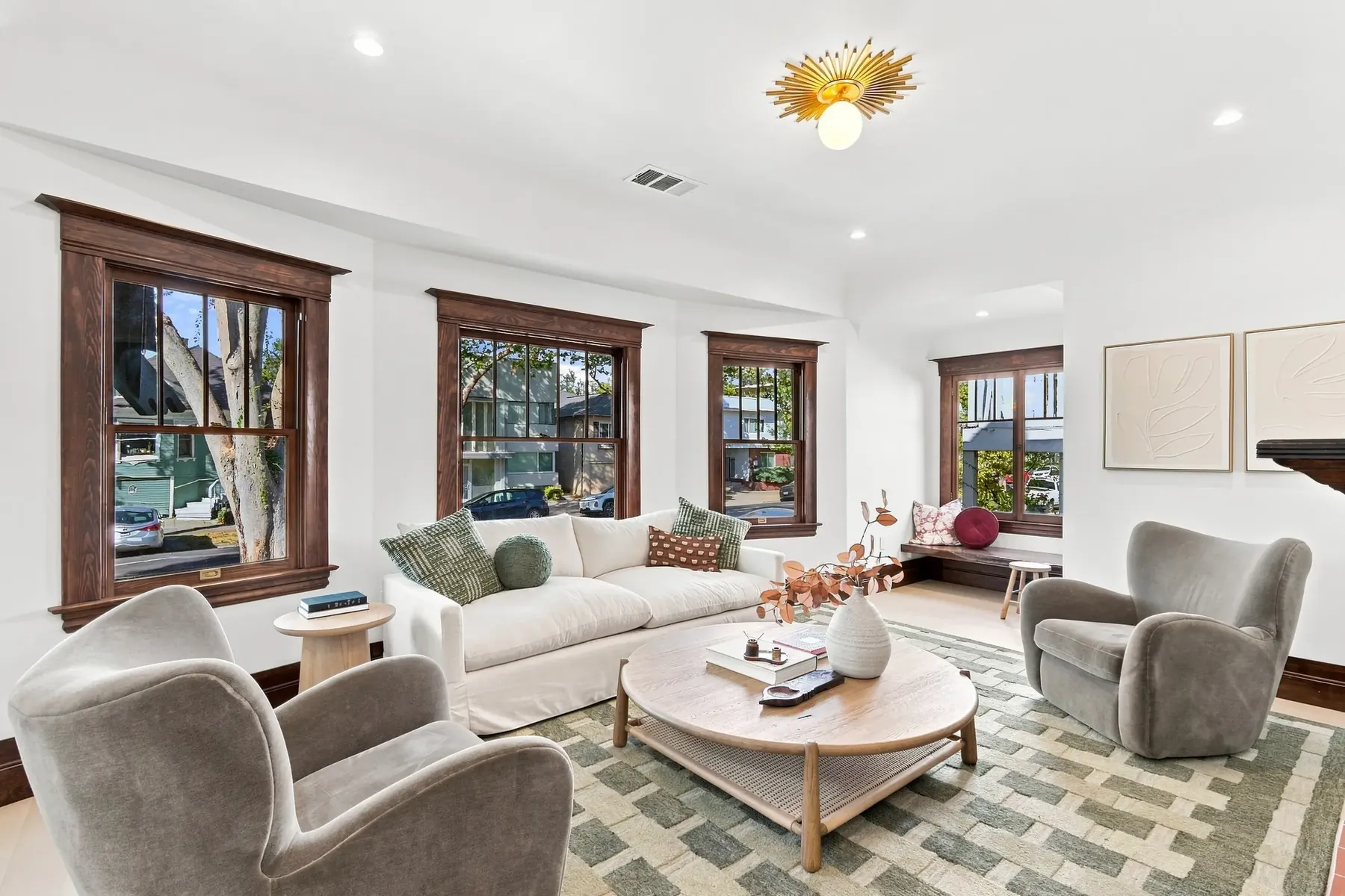 The front living room. Four original double-hungs in stained casing were kept and reglazed.