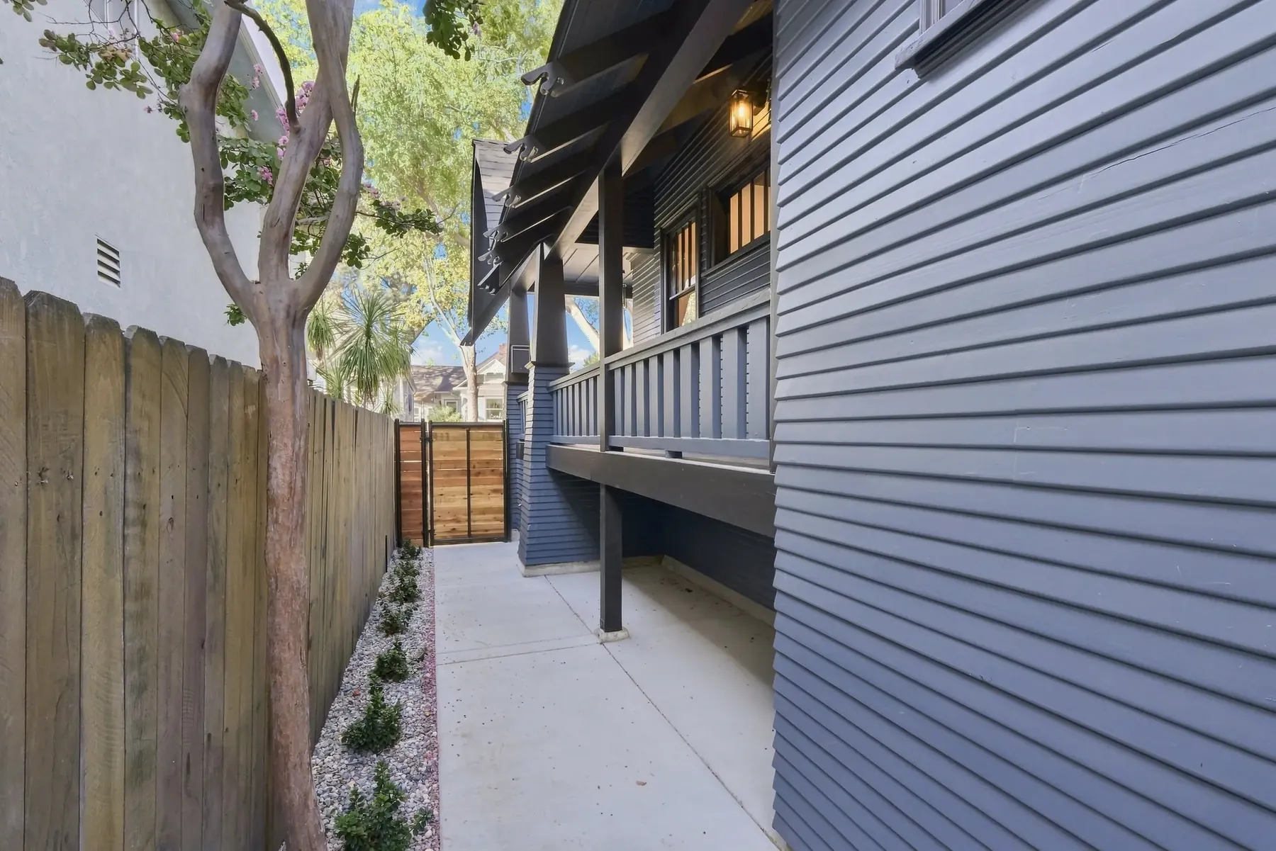 Side yard circulation. New fence, concrete banding and gravel joints run the length of the house to the rear deck.